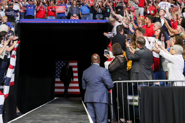 A U.S. Secret Service agent and supporters of U.S. President Donald Trump watch as he arrives at his first re-election campaign rally in several months in the midst of the coronavirus disease (COVID-19) outbreak, at the BOK Center in Tulsa, Oklahoma.